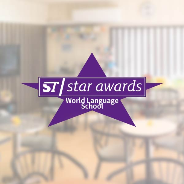 Purple logo of star awards - world language school
